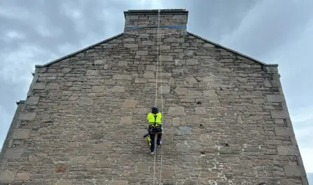 Rope access technicians cleaning a high-rise building facade