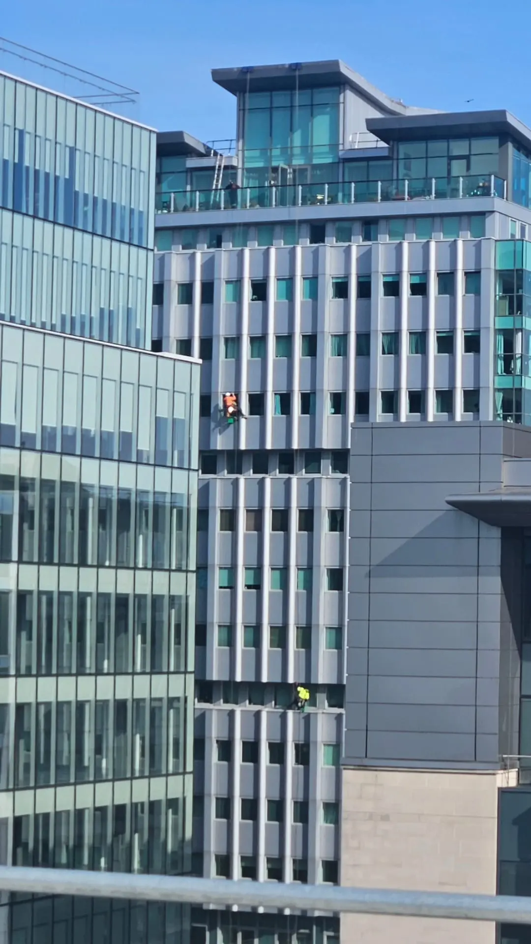 Rope access window cleaner working on an office block