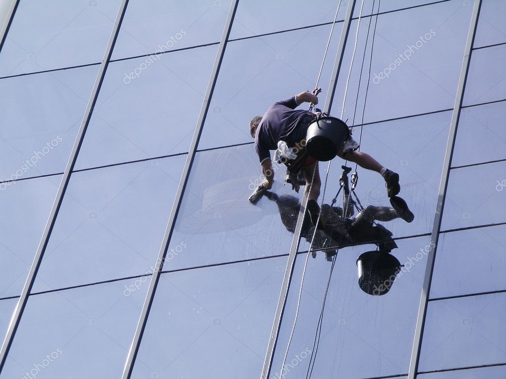 Rope access window cleaner working on an office block