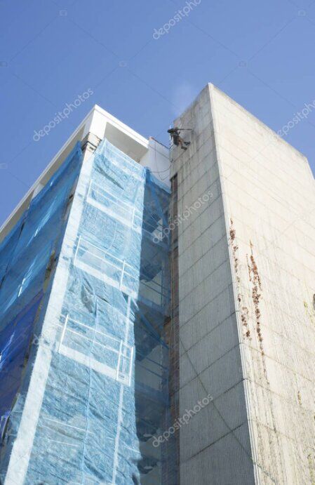 Rope access technicians cleaning a high-rise building facade