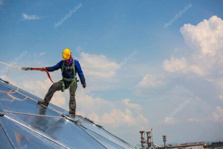 Rope access technician working safely on the side of a building