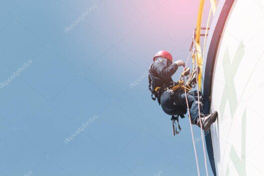 Rope access technicians cleaning a high-rise building facade